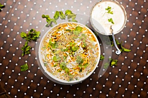 Murgh Dum Biryani or chiicken Dum Biriyani with raita served in a dish isolated on table background top view of bangladesh food