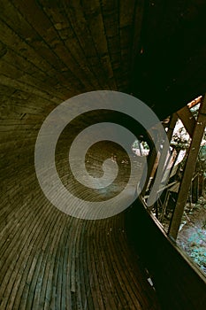 Murjani luge track in Latvia. Abandoned and old wooden luge track. Sunlight shining through the cracks. Vintage filter and moody