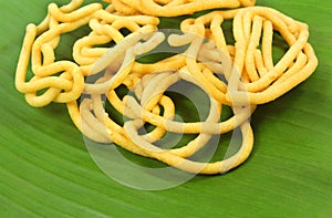 Murukku indian recipe on natural banana leaf photo