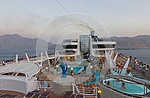 Muscat, Oman: Tourists on the open deck of cruise liner MSC Splendida near Muscat fjords