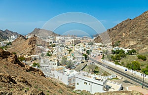 Muscat Takia historical city center streets overview panorama with rocks and Arabian sea in the background, Oman