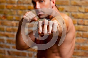 Muscle boxer shaped man fist to camera
