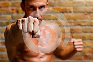 Muscle boxer shaped man fist to camera