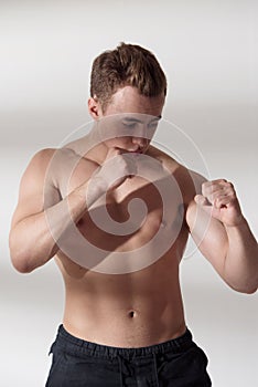 Muscle fighter man in fighting stance