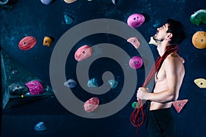 Muscle male man climbing bouldering in training hall