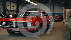 Muscle red car in a car shop center. Vintage classic sport car garage