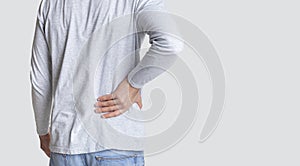 Muscle spasm, rheumatism. Man holds to his back with hand