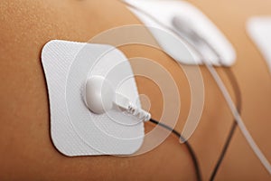 Muscle stimulator with electrodes, the massager on the buttocks and legs