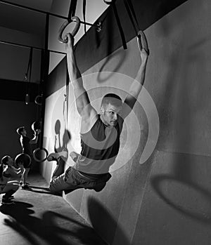 Muscle ups rings man swinging workout at gym
