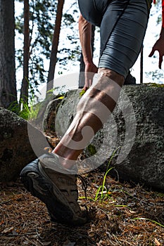 Muscled legs of the trail running athlete