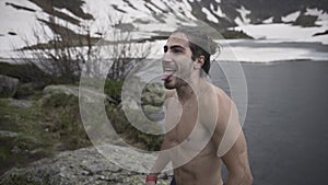 Muscled man comes out of the water with a very cold body in Andorra