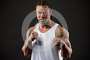 Muscular African American Man Black Sweaty Boxer Yells Aggressively at Camera with Dramatic Lighting on Black Background