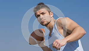 Muscular american football player ready to throw ball