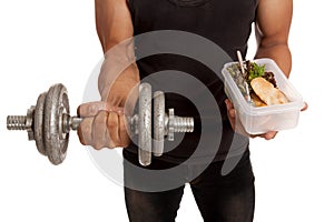 Muscular Asian man with dumbbell and clean food in box