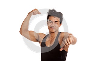 Muscular Asian man flexing biceps and thumbs down