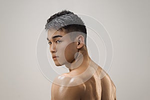 Muscular Asian Man Indoors in th Studio