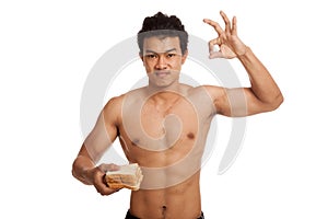 Muscular Asian man load carbs with some bread show OK