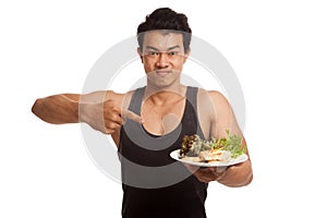 Muscular Asian man point to clean food