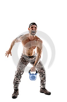 Muscular athlete bodybuilder man in camouflage pants with a nake