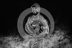 Muscular athlete posing in the studio. Fitness and classic bodybuilding concept