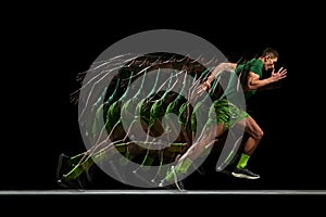 Muscular, athletic man in full motion, training, running against black background with stroboscope effect. Development