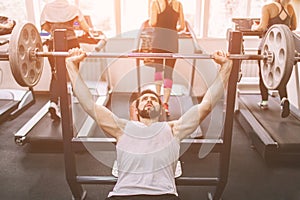 Muscular Bearded man during workout in the gym.