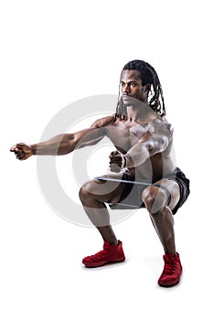 Muscular black man exercising with elastic bands