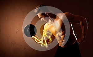 Muscular body builder lifting weight with energy lights on bicep
