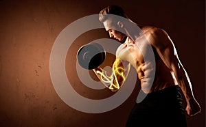 Muscular body builder lifting weight with energy lights on bicep