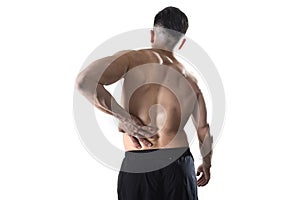 Muscular body sport man holding sore low back waist massaging with his hand suffering pain