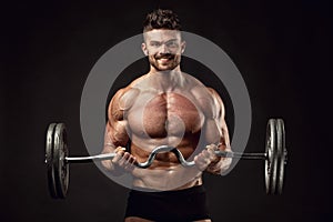 Muscular bodybuilder guy doing exercises with big dumbbell