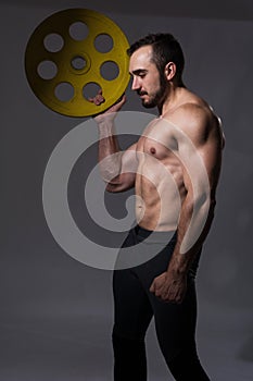 Muscular bodybuilder guy doing exercises with dumbbell