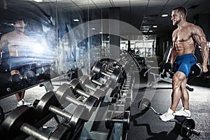 Muscular bodybuilder guy doing exercises with dumbbell