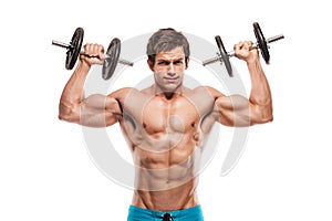 Muscular bodybuilder guy doing exercises with dumbbells