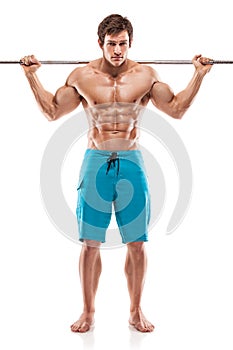 Muscular bodybuilder guy doing exercises with dumbbells over white background