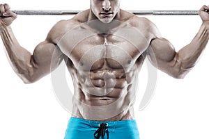 Muscular bodybuilder guy doing exercises with dumbbells over white background background and showing abdominal muscle