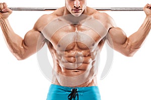 Muscular bodybuilder guy doing exercises with dumbbells over white background background and showing abdominal muscle