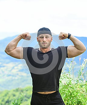 Muscular bodybuilder outdoor. show biceps and triceps muscles. male power. strong sportsman. athlete in sport wear photo