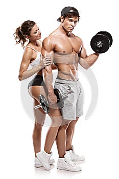 Muscular bodybuilder with woman doing exercises with dumbbells