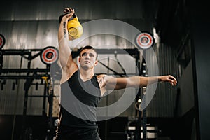 Muscular fit man with perfect beautiful body wearing sportswear lifting heavy free weights