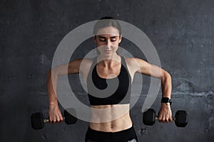 Muscular fit woman exercising building muscles at gym