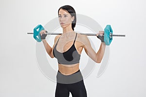 Muscular fit woman with fitness barbell