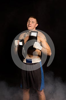 Muscular fit young boxer preparing for a fight