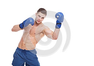 Muscular guy in boxing glove punches an uppercut on a white isolated background