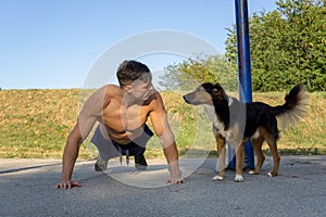 Muscular guy workout with dog