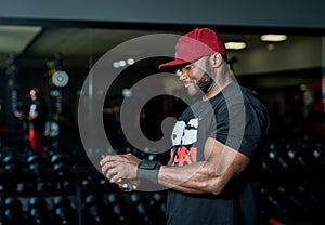 Muscular handsome afro man in the gym. Lifestyle strong bodybuilder with athlete torso.