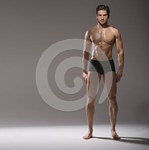 Muscular handsome guy in calm pose photo