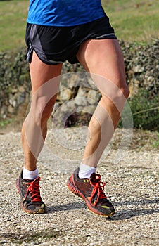 Muscular legs of the fast runner during the cross country race