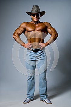 Muscular male in a hat and sunglasses