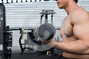 Muscular male having pain on shoulder in gym. young man injure